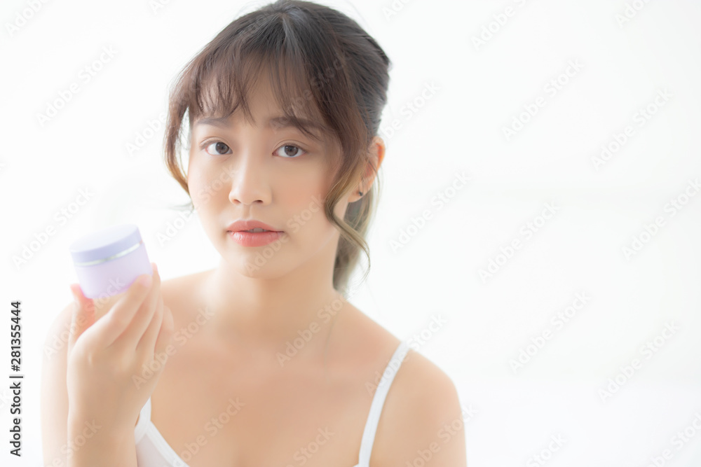 Beautiful portrait young asian woman holding and presenting cream or lotion product, beauty asia girl show cosmetic makeup and moisturizing for skin care, healthy care and wellness concept. Beautiful portrait young asian woman holding and presenting cream or lotion product, beauty asia girl show cosmetic makeup and moisturizing for skin care, healthy care and wellness concept.