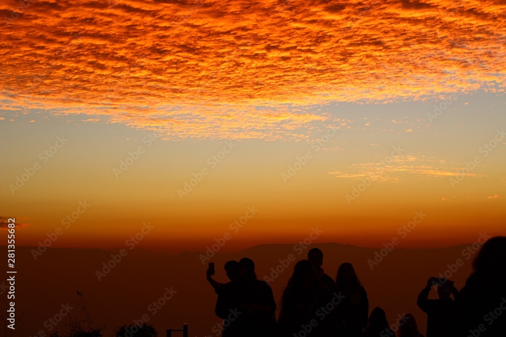 people on beach at sunset