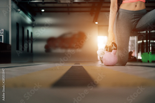 sport woman at fitness gym club doing exercise for arms with kettlebell and showing muscle bodybuilding, fitness concept, sport concept