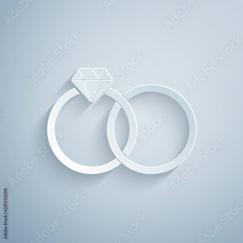 Paper cut Wedding rings icon isolated on grey background. Bride and groom jewelery sign. Marriage icon. Diamond ring. Paper art style. Vector Illustration