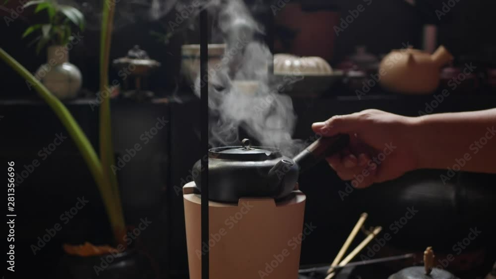 Traditional Chinese metal teapot on a clay stove boils the water for the tea ceremony. Closeup. 4k Traditional Chinese metal teapot on a clay stove boils the water for the tea ceremony. Closeup. 4k