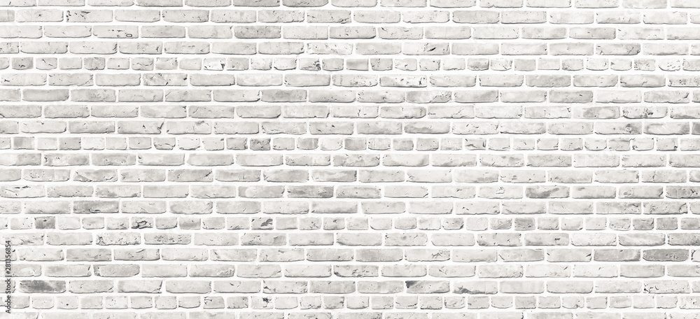 White brick wall. Simple grungy white brick wall with light gray shades pattern surface texture background in wide panorama format. White brick wall. Simple grungy white brick wall with light gray shades pattern surface texture background in wide panorama format.
