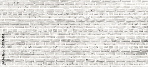 White brick wall. Simple grungy white brick wall with light gray shades pattern surface texture background in wide panorama format.