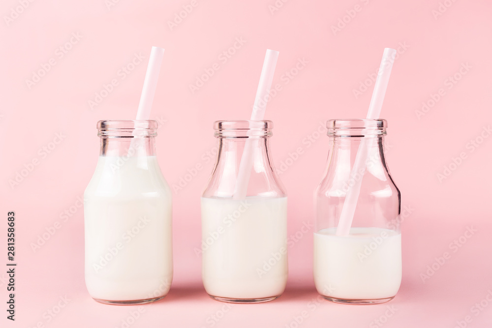 Three bottles of milk of yogurt on pink background. Three bottles of milk of yogurt on pink background.