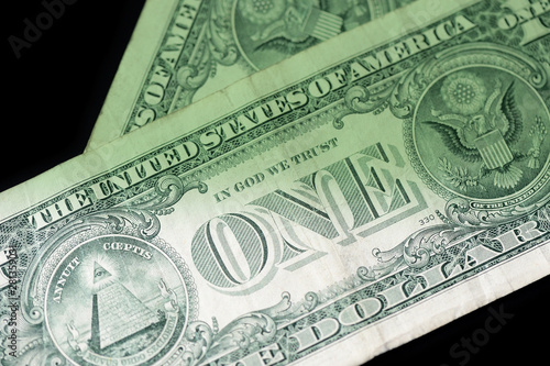 Dollar bills on dark background close up. Money background green color toned