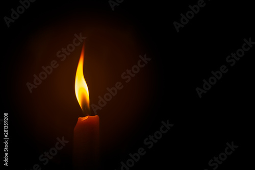 one burning candle decoration against black background