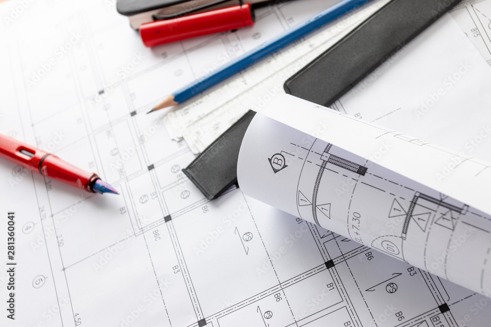 Rolls of architecture blueprints and house plans on the table and architect drawing tools. Rolls of architecture blueprints and house plans on the table and architect drawing tools.