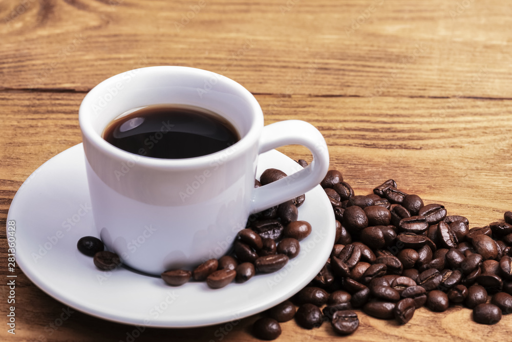 A cup of coffee and scattered coffee beans. Layout. Flat lay. Coffee bean. A cup of coffee and scattered coffee beans. Layout. Flat lay. Coffee bean.