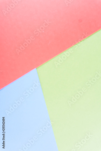 Flat layout of minimal colourful layer of pastel red, green and blue paper background.