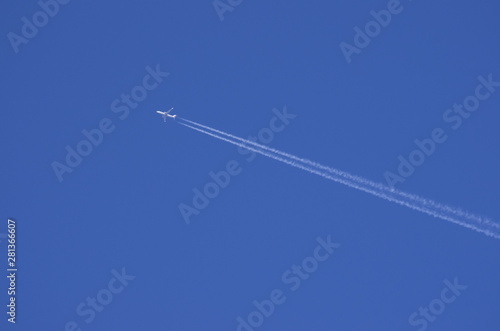 airplane contrail in blue sky