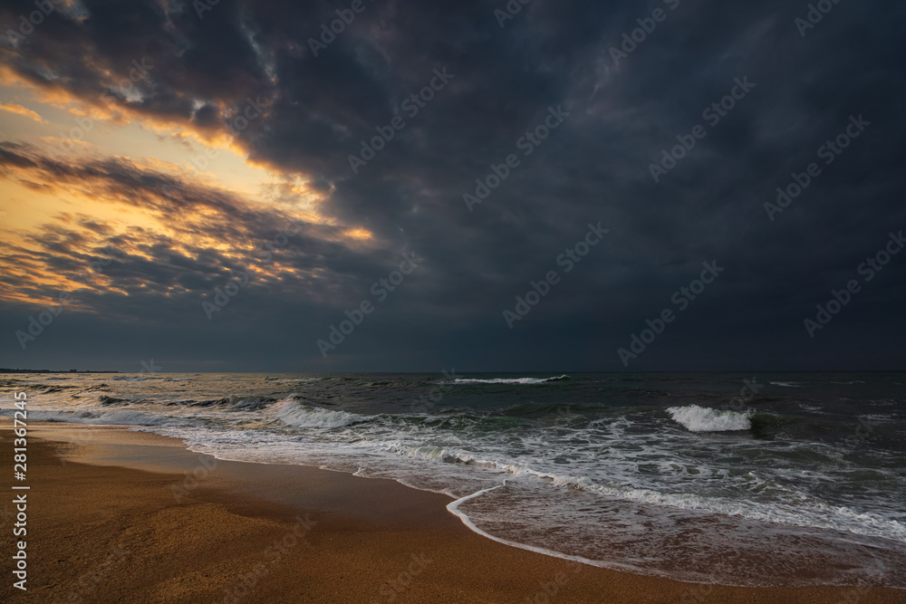 Fototapeta premium Dark stormy sea and empty beach
