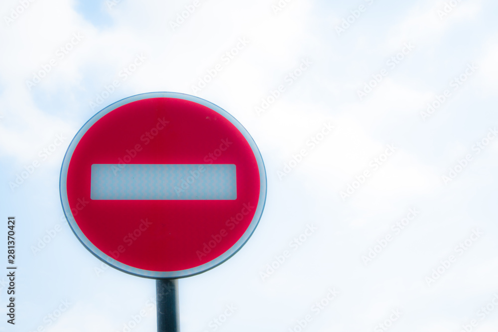 Road sign against the sky. White strip on a red background. Round sign Road sign against the sky. White strip on a red background. Round sign