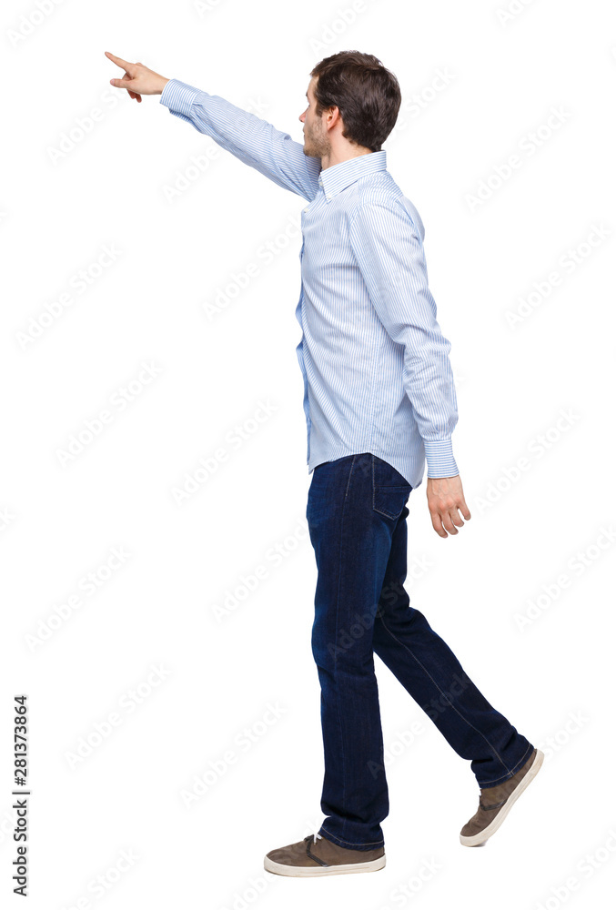 Back view of a man walking with a pointing hand. Back view of a man walking with a pointing hand.