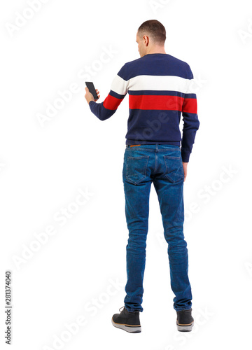 Back view of man who is looking into the smartphone. © ghoststone