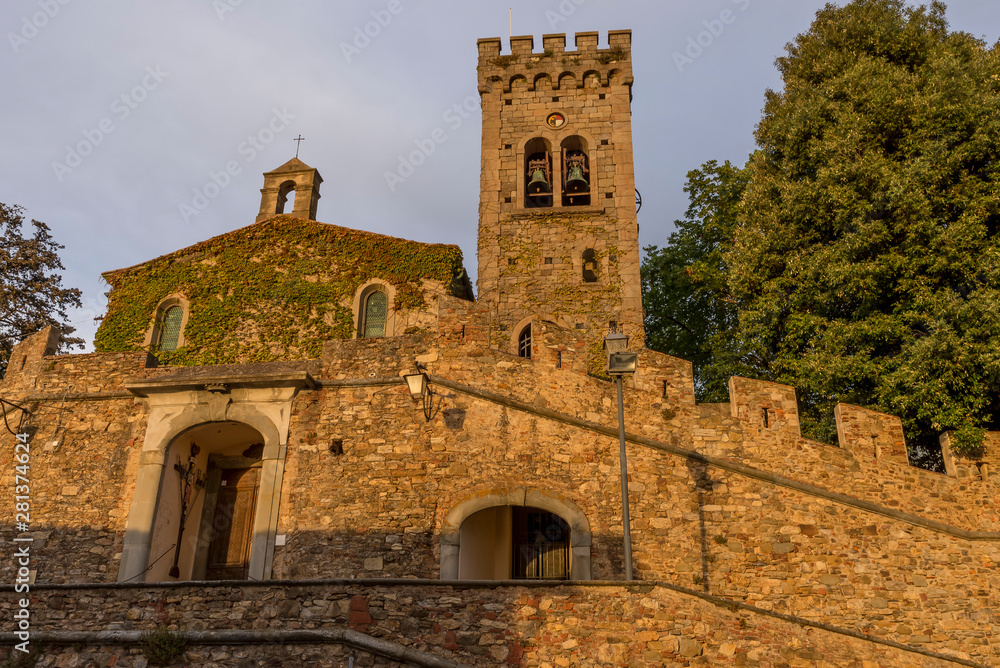 The Church of San Lorenzo illuminated by the setting sun in the medieval village of Castagneto Carducci, Tuscany, Italy