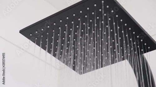 Water starts flowing from modern square large shower head