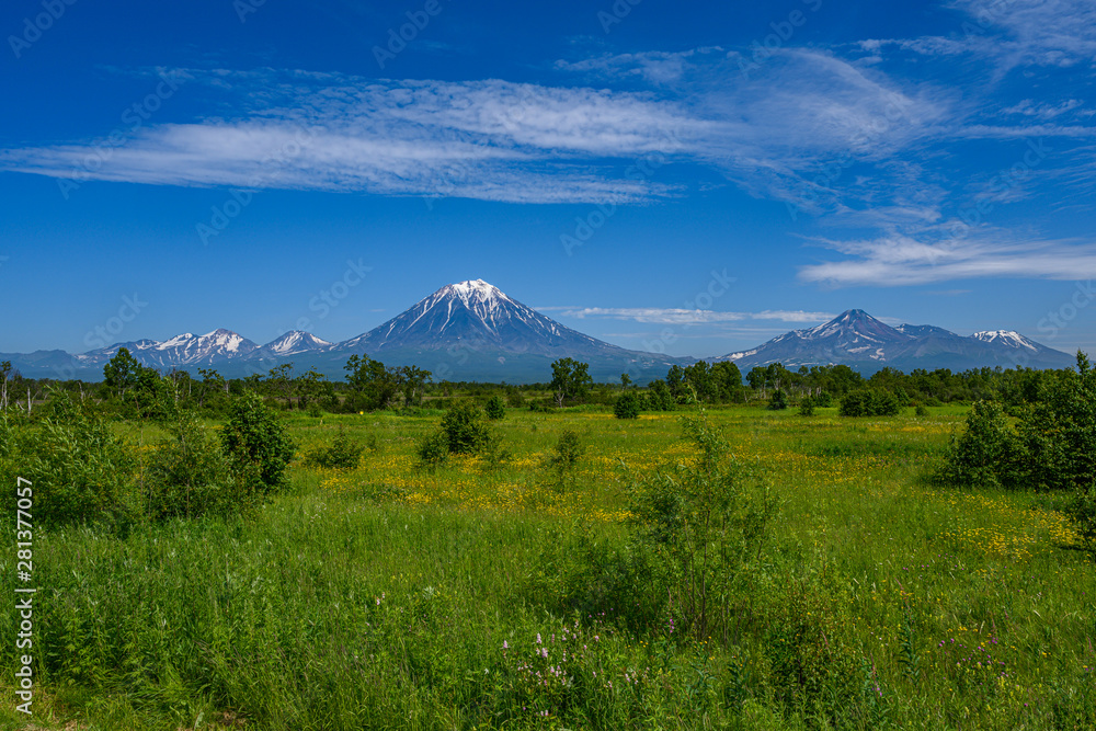 Panoramic view of the city Petropavlovsk-Kamchatsky and volcanoes: Koryaksky Volcano, Avacha Volcano, Kozelsky Volcano. Russian Far East, Kamchatka Peninsula.