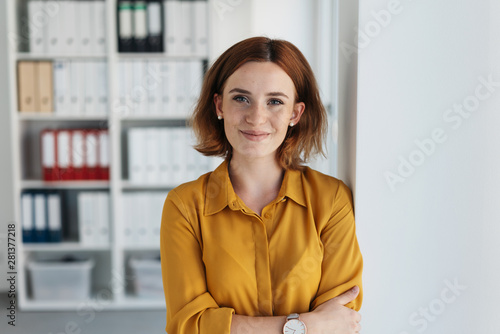 Self-assured relaxed young businesswoman