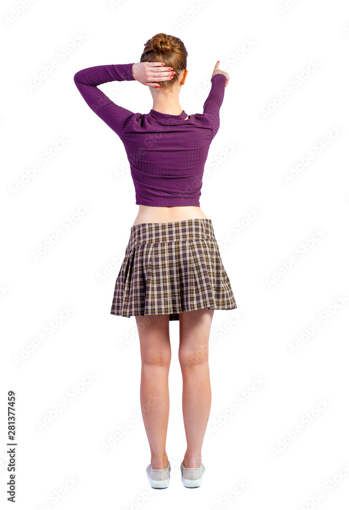 Back view of a woman points his hand upwards. Back view of a woman points his hand upwards.