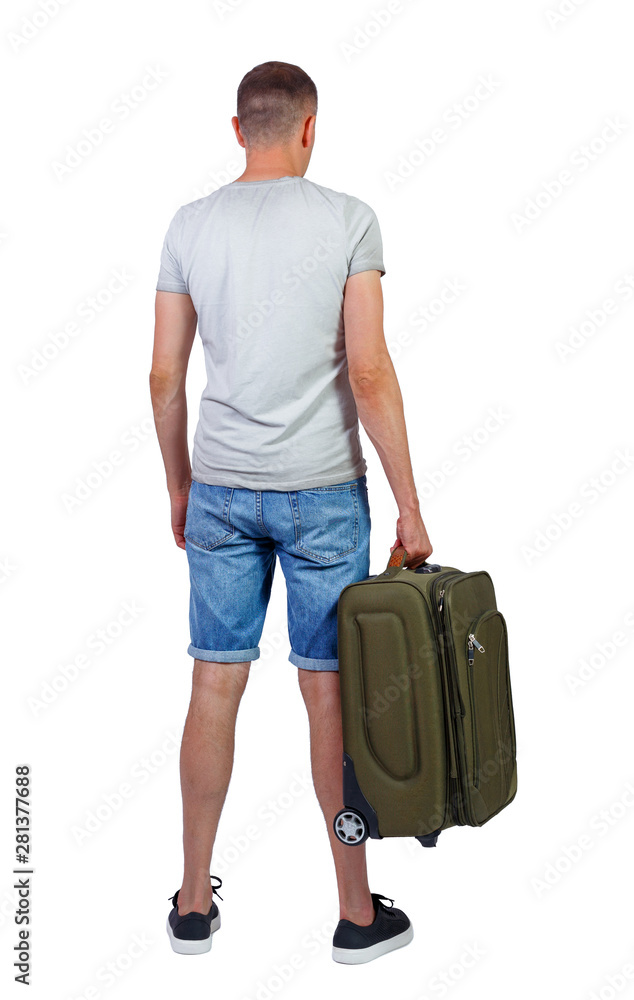 Back view of man in shorts with suitcase. Back view of man in shorts with suitcase.