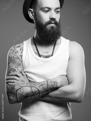 man in hat. boy with tattoo. Black and white portrait