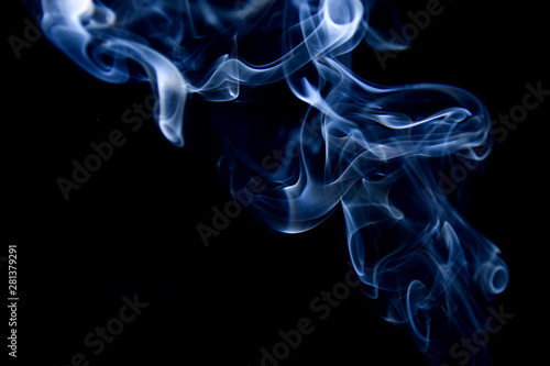 Blue incense smoke on a black background.