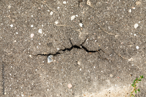 Big crack in sidewalk, top view, close-up shot © Glevalex