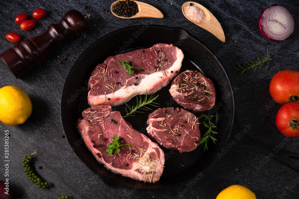 Fresh raw Prime Black Angus beef steaks on wooden board: Tenderloin, Denver Cut, Striploin, Rib Eye Fresh raw Prime Black Angus beef steaks on wooden board: Tenderloin, Denver Cut, Striploin, Rib Eye