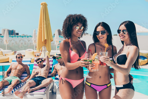 Portrait of lovely girlfriends brunettes toasting wearing bikini eyewear eyeglasses chilling standing outdoors