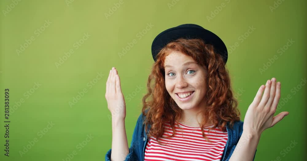 Portrait of cheerful girl in trendy hat playing hide-and-seek then smiling on green background. Joyful millennials, emotions and happy young people concept. Portrait of cheerful girl in trendy hat playing hide-and-seek then smiling on green background. Joyful millennials, emotions and happy young people concept.
