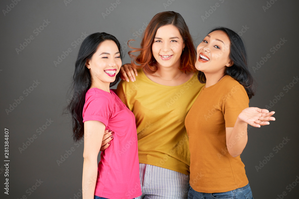 Portrait of Asian happy group of friends embracing each other and smiling at camera isolated on grey background Portrait of Asian happy group of friends embracing each other and smiling at camera isolated on grey background