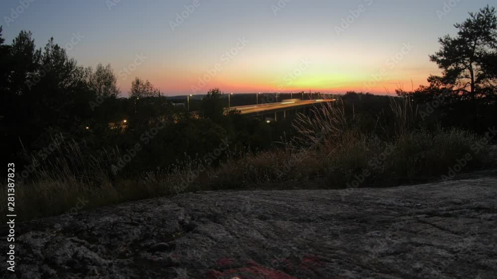 Time lapse of a sunset captured on a hill in Liljeholmen in Stockholm facing the motor highway Essingeleden.