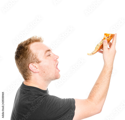 The guy eats a slice of pizza isolated on white background