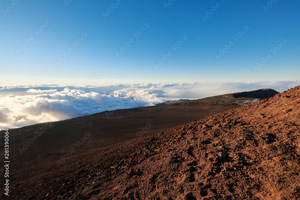 rocky volcanic landscape above the clouds