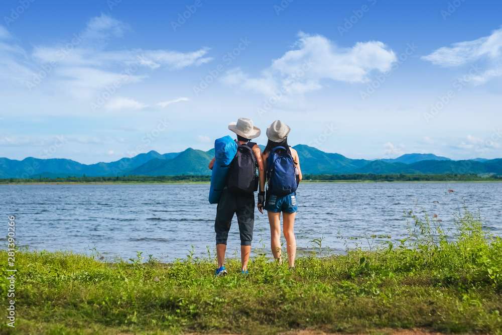 couple traveler standing near the lake background is the mountain and enjoying for beautiful view of nature on holiday.adventure concept. couple traveler standing near the lake background is the mountain and enjoying for beautiful view of nature on holiday.adventure concept.