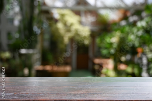 Wood desk in garden background with empty table.