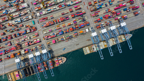 Aerial view cargo ship terminal, Unloading crane of cargo ship terminal, Aerial view industrial port with containers and container ship.