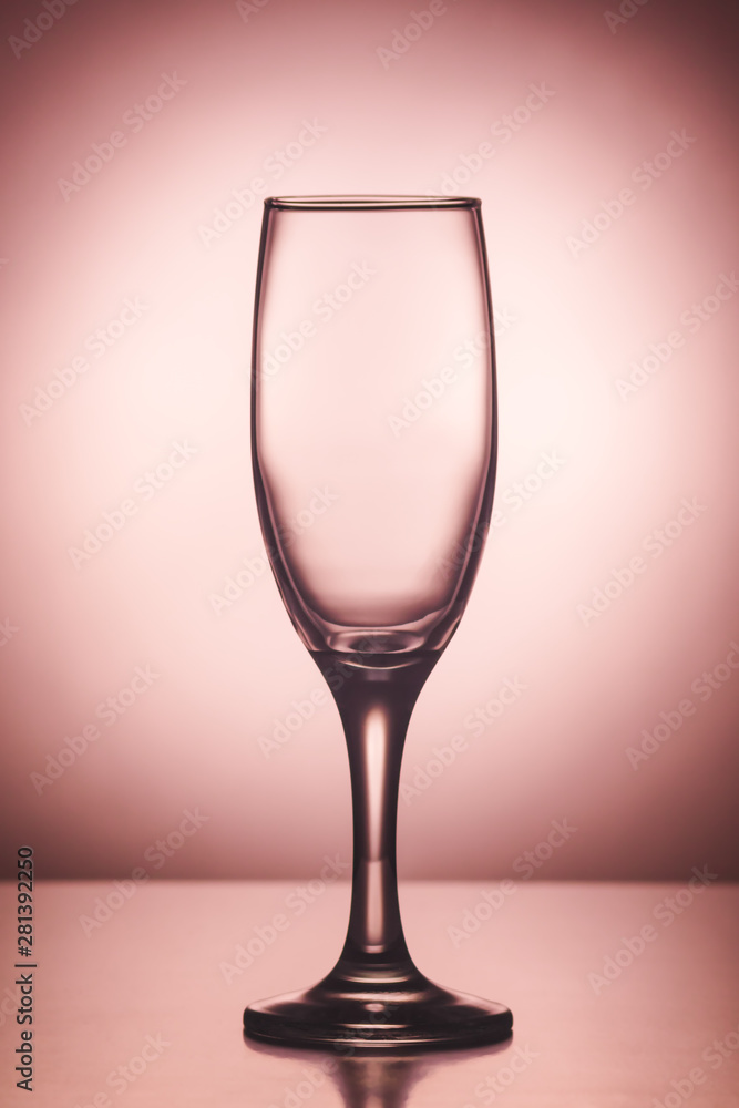 Obraz premium Empty champagne wine glass on pink background 