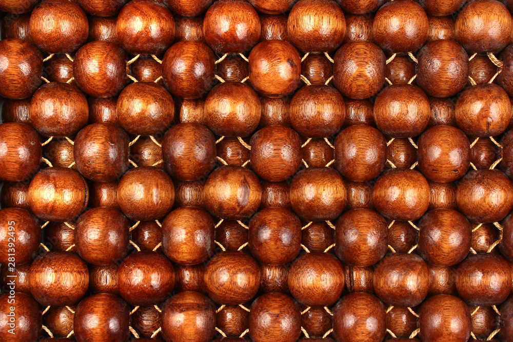 Wooden beads rug. Hand made car seat. Natural varnished wood background. Wooden beads rug. Hand made car seat. Natural varnished wood background.