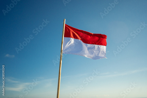 Obraz na plátně indonesia flag under blue sky raising red and white flag