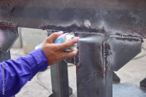 Penetrant Test , worker apply developer to the welding of structure for finding the defect.