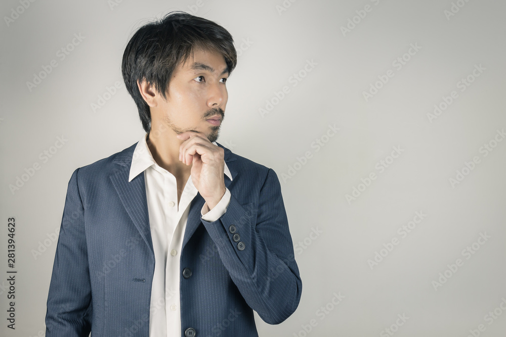 Portrait Man in Navy Blue Suit Looking Above and Touch Chin Pose Vintage Tone Portrait Man in Navy Blue Suit Looking Above and Touch Chin Pose Vintage Tone