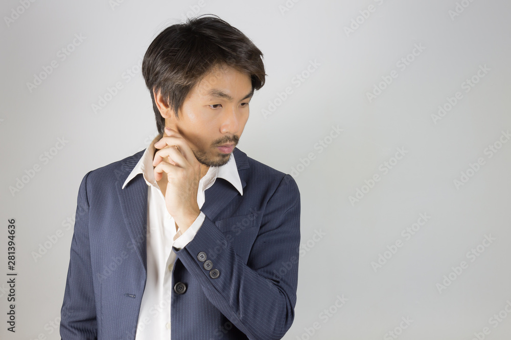 Portrait Man in Navy Blue Suit Looking Below and Touch Chin Pose Portrait Man in Navy Blue Suit Looking Below and Touch Chin Pose