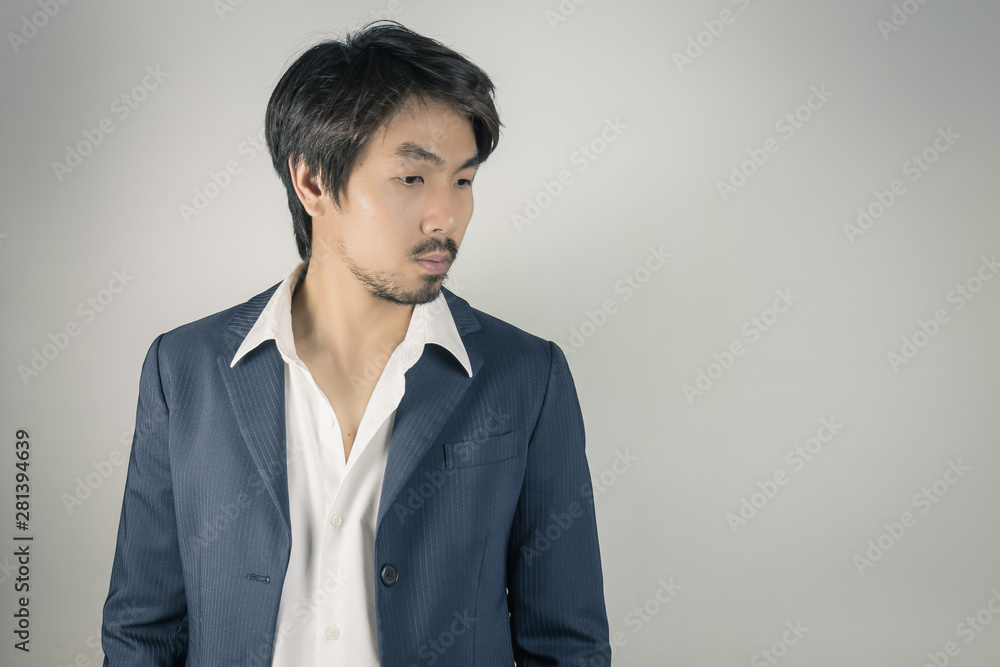 Portrait Man in Navy Blue Suit Looking Below Vintage Tone Portrait Man in Navy Blue Suit Looking Below Vintage Tone
