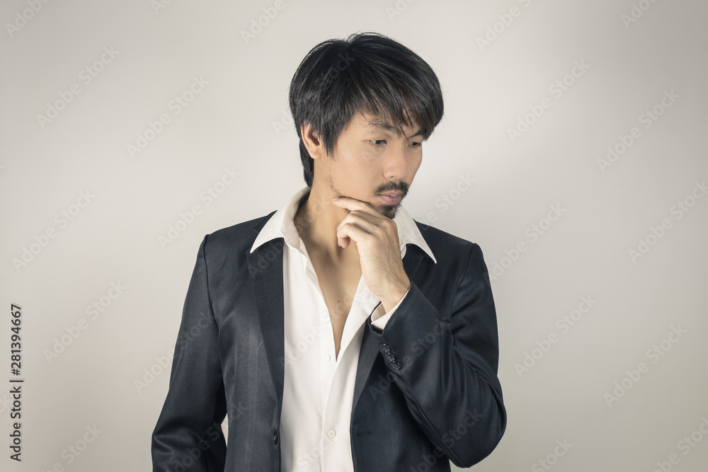 Portrait Businessman in Black Suit Fashion Touch Chin Pose in Vintage Tone Portrait Businessman in Black Suit Fashion Touch Chin Pose in Vintage Tone