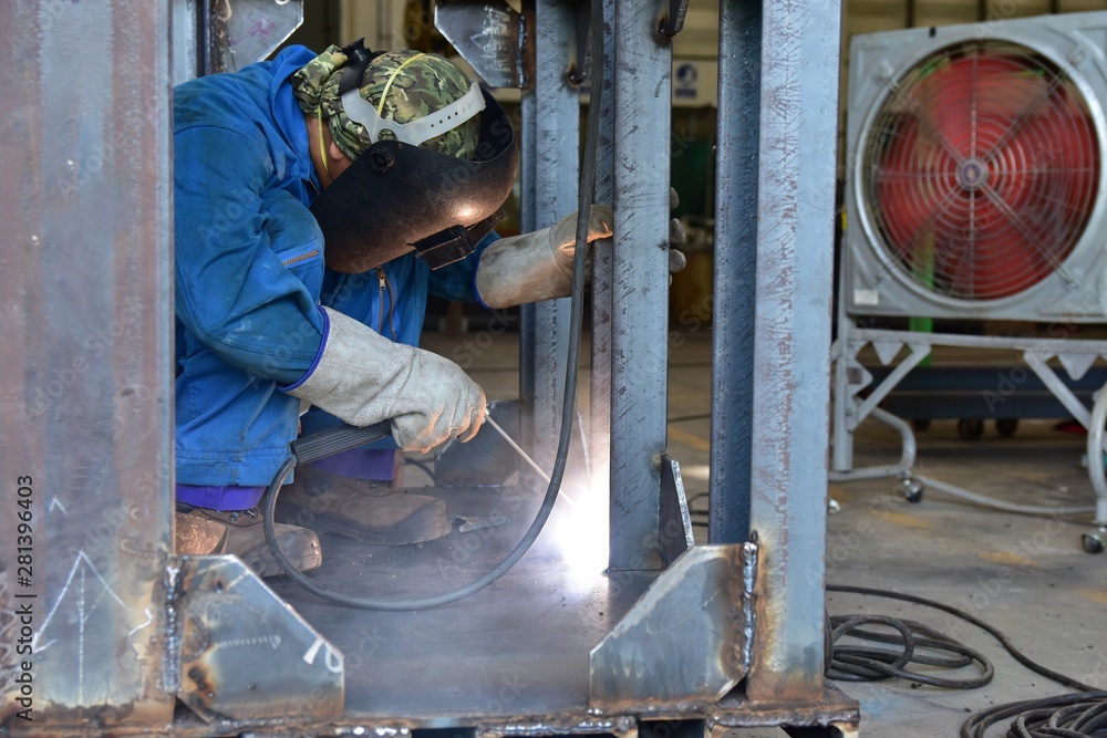 Welder is assembling the workpiece by process shielded metal arc