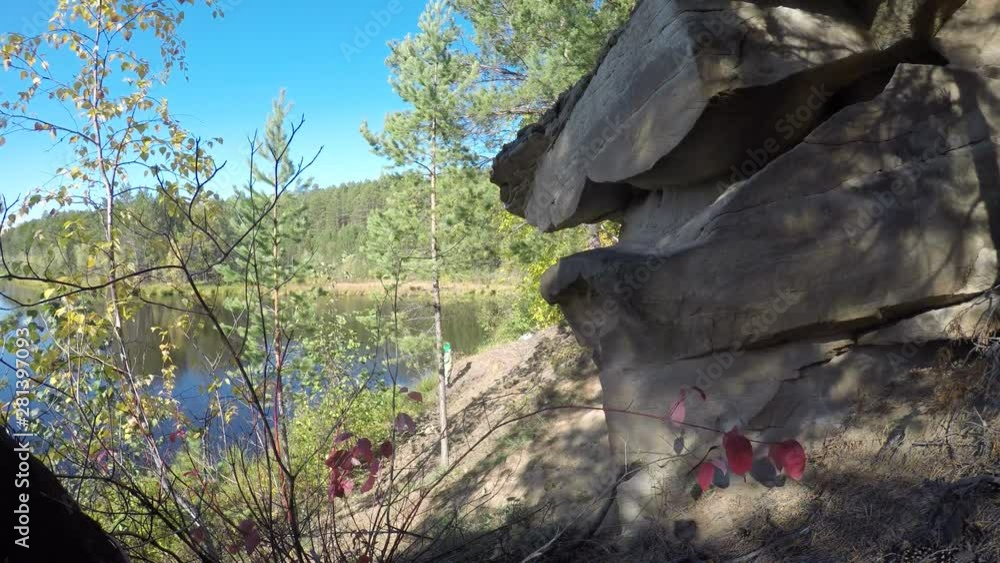 Accelerated video fishing men and women in the wild taiga of Yakutia shot among the trees of the forest and smooth stone with the movement of grass near the lake. Accelerated video fishing men and women in the wild taiga of Yakutia shot among the trees of the forest and smooth stone with the movement of grass near the lake.