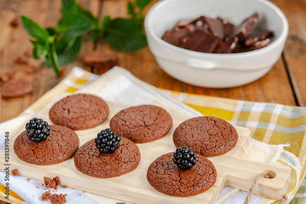 Chocolate cookies , mint, blackberries and crushed chocolate on a wooden table Chocolate cookies , mint, blackberries and crushed chocolate on a wooden table
