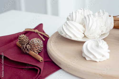 Marshmallow on a plate, white meringue marshmallow background. Flat lay. View from above. Berry sweet homemade marshmallows on a wooden stand. Traditional Russian white homemade marshmallows.