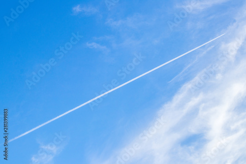 The contrails or the condensation trails in the blue sky background